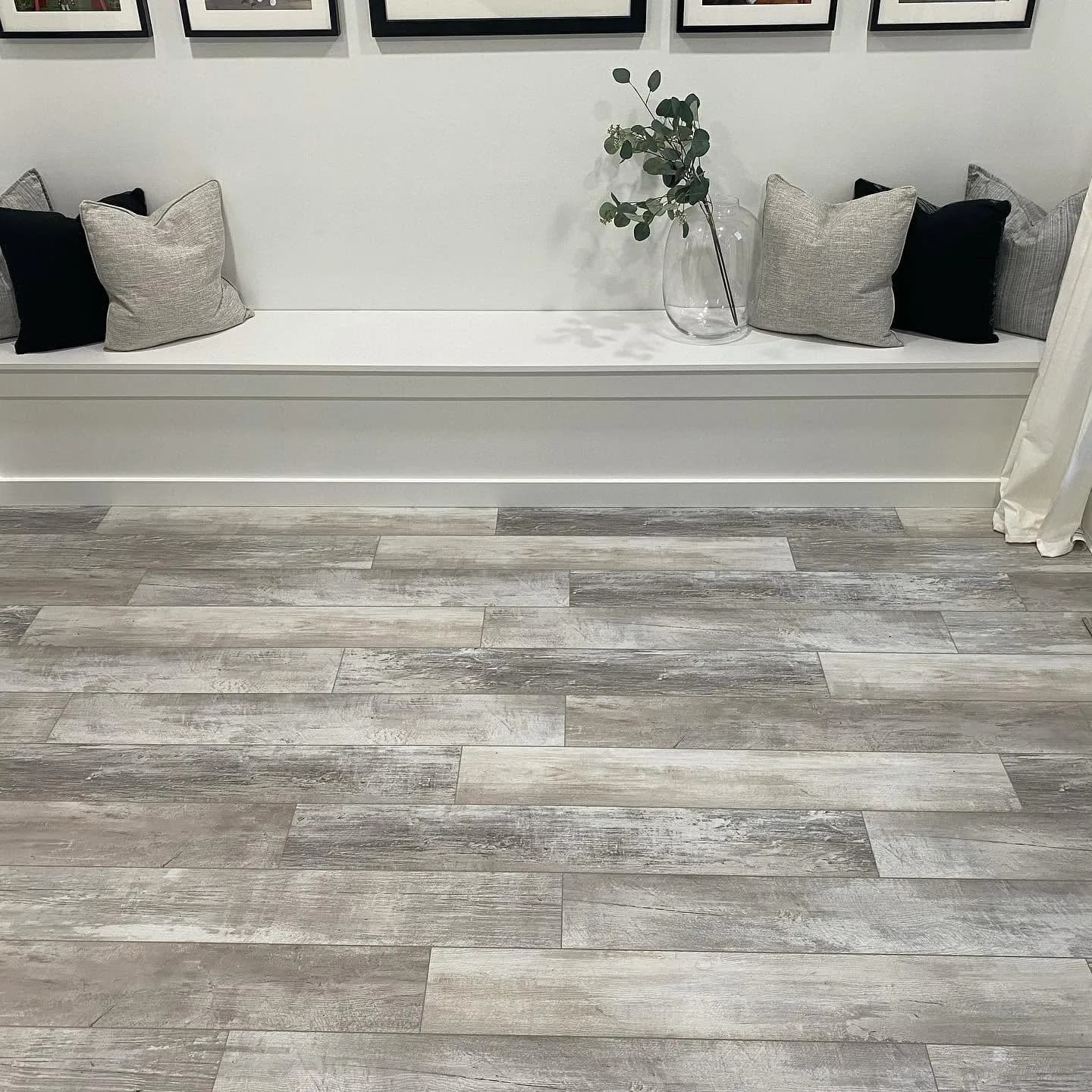 Gray wood-look plank flooring with built-in bench