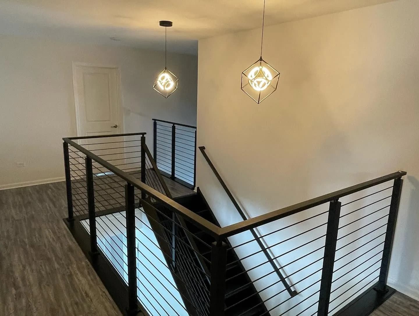 Modern black horizontal-rod railing with wood cap