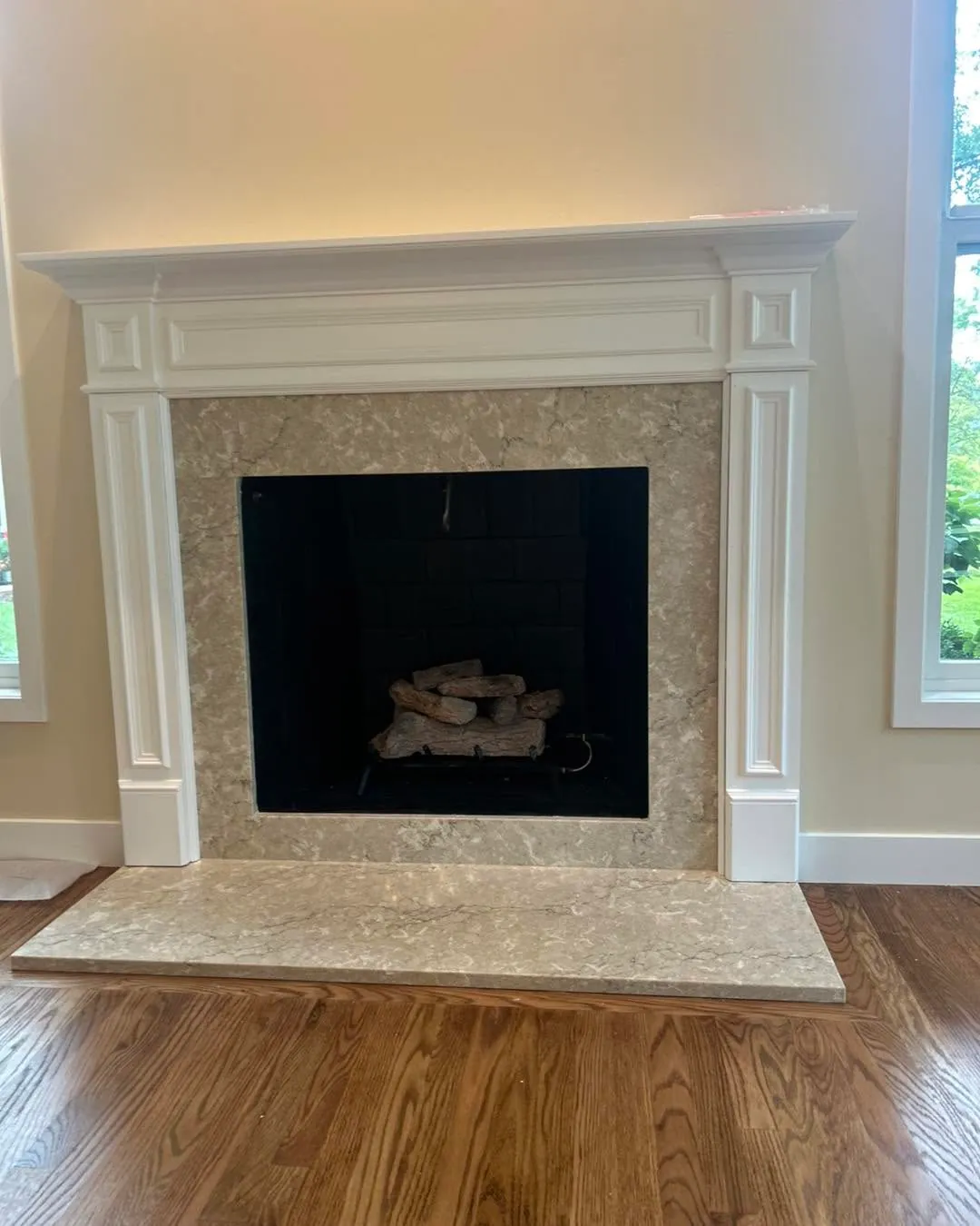 White fireplace mantel with quartz surround