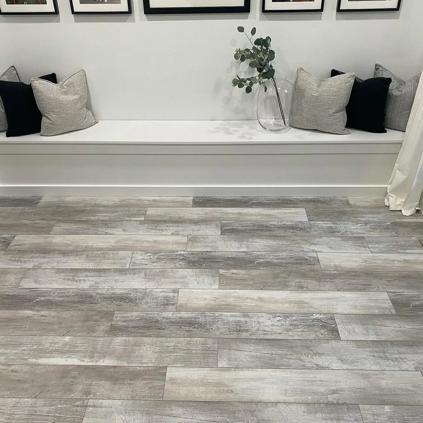 Gray wood-look plank flooring with built-in bench
