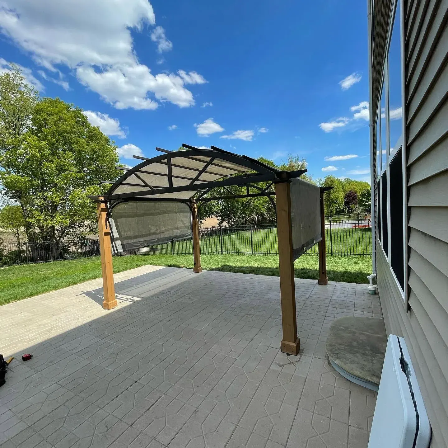 Arched pergola over a stamped-paver patio